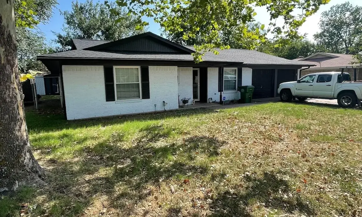 Professional roofing crew working on a residential roof in Rosenberg